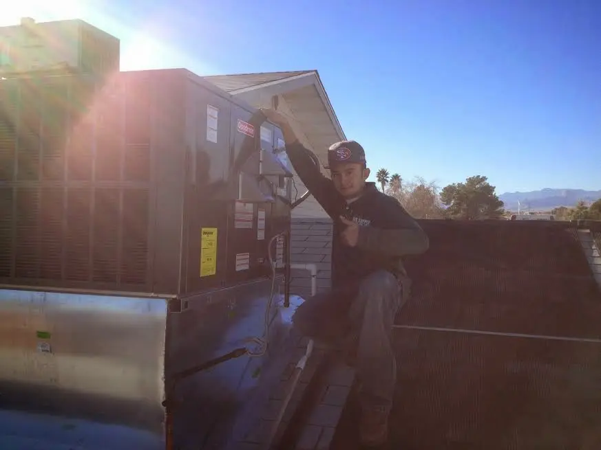 HVAC technician performing Boiler Repair on a rooftop unit in Frankstown